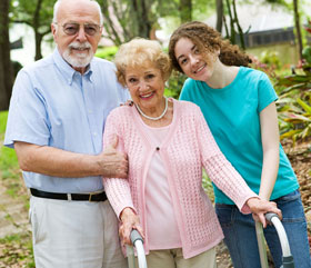 Happy patient poses with her husband and granddaughter